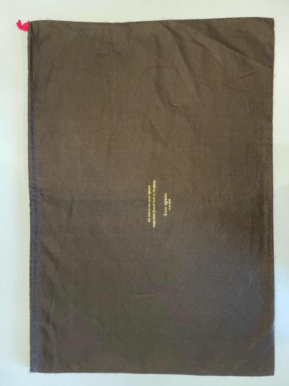 Kate Spade Brown Dust Bag with coral lipstick quote in gold